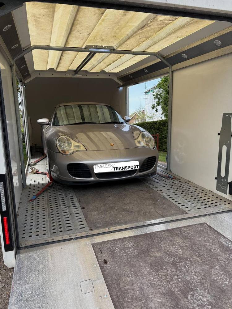 Enclosed trailer open with a Porsche 911 loaded