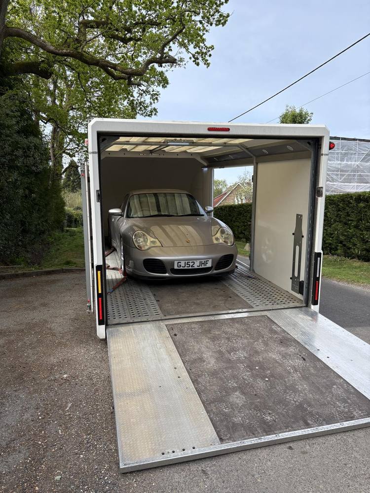 Porsche 911 inside the enclosed trailer