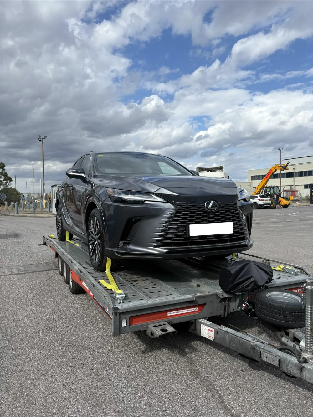 Lexus RX loaded and strapped on the open trailer