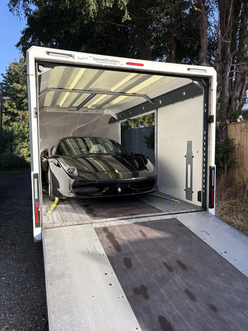 Black Ferrari loaded inside the Timeless Transport enclosed trailer