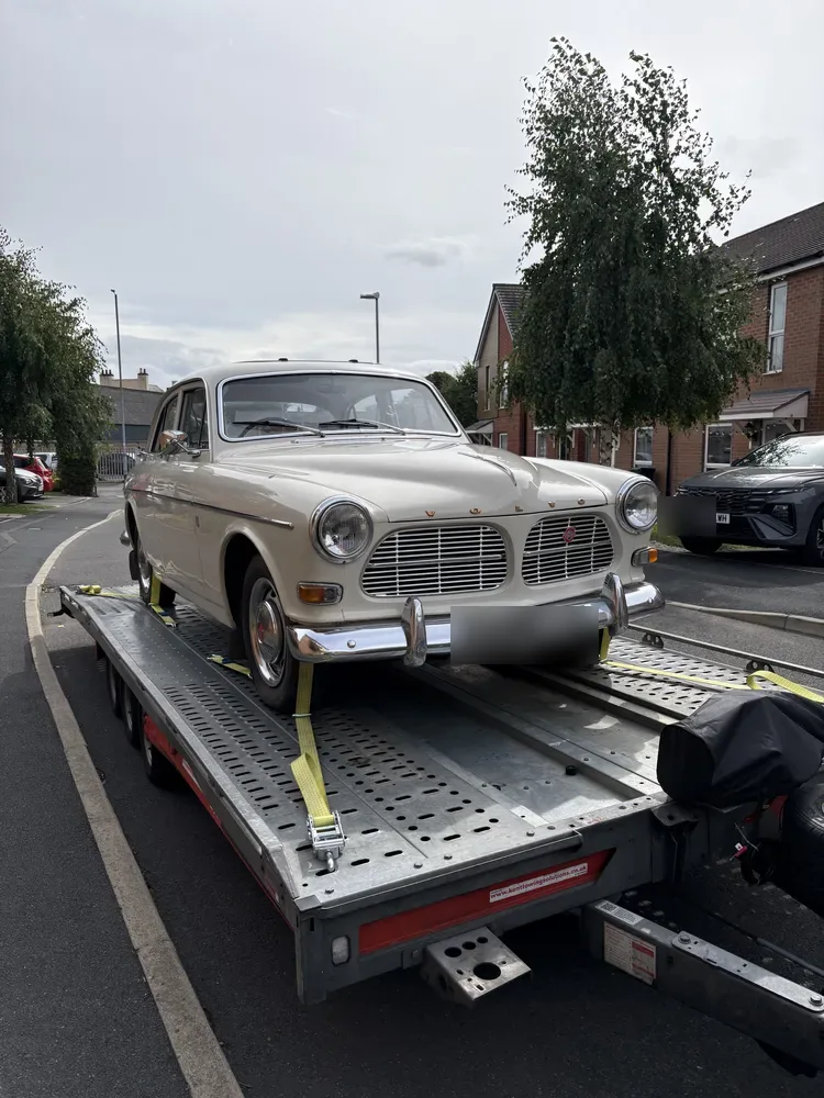 Cream Volvo Amazon classic strapped down on the Timeless Transport trailer