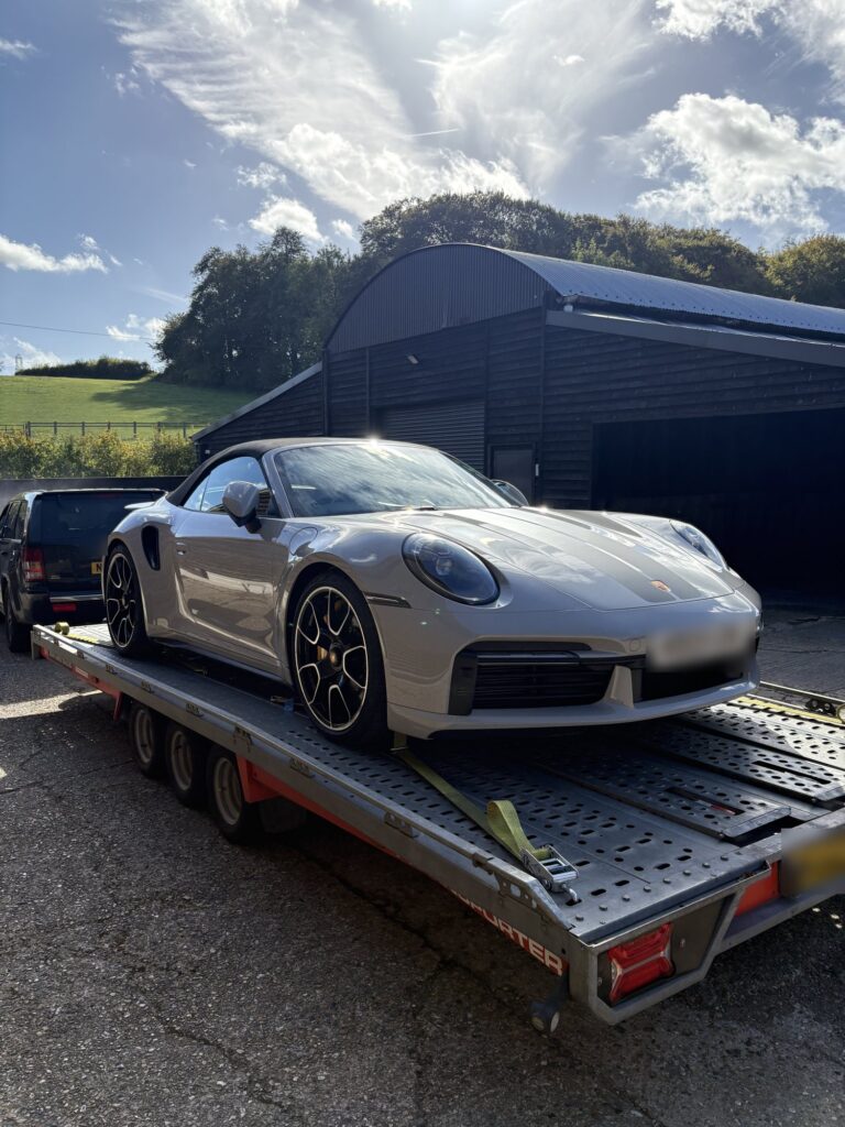 Grey Porsche 911 Turbo S cabriolet secured on the Timeless Transport open transporter